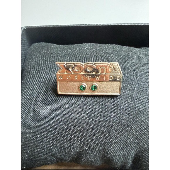 Jewelry - Xooma Worldwide badge (gold-tone, with a green faux stone)